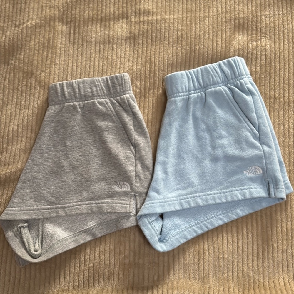 Two pairs of North Face sweatshorts (blue and grey)